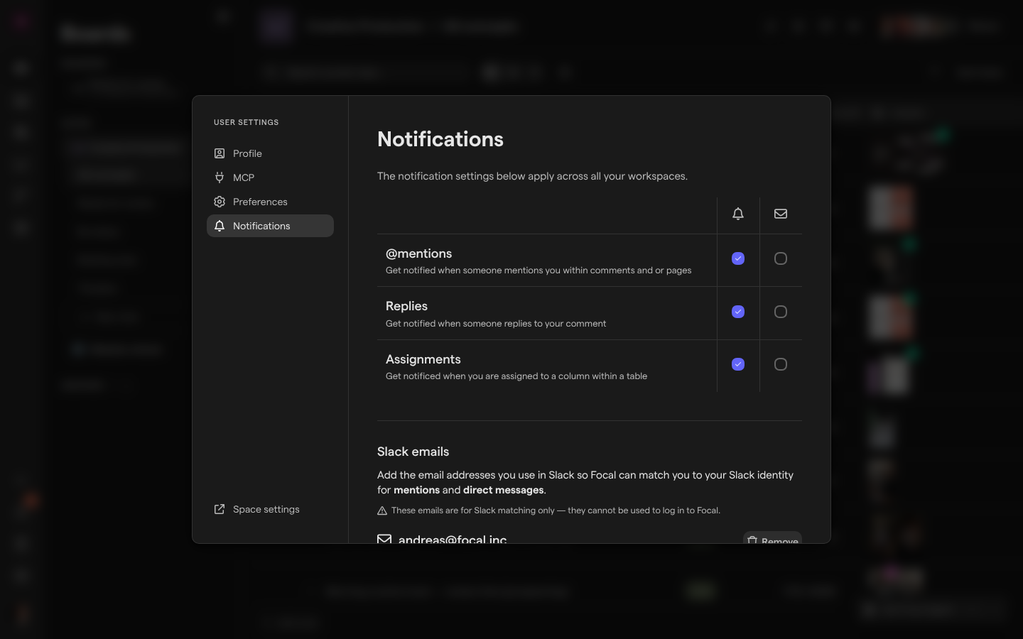 The Notifications page of User Settings, with In App selected and Email cleared for @mentions, Replies and Assignments, and the Slack emails list below.